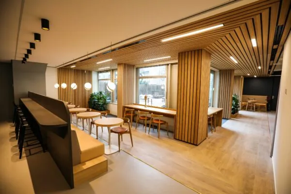 Moderne en sfeervolle ontmoetingsruimte met houten interieur, zitplekken en grote ramen, getiteld 040_2160.