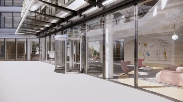 Ingang van een modern kantoorgebouw aan de Europalaan met glazen gevel en draaideur.