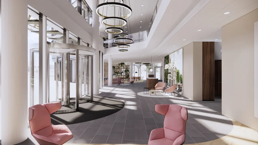 Moderne, lichte entreehal van een kantoorgebouw aan de Europalaan met designmeubilair en glazen draaideuren.