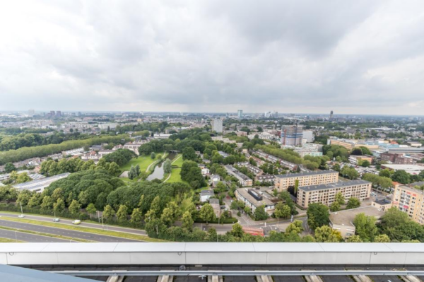 Luchtfoto van het Herculesplein in Utrecht met uitzicht op woonwijken, groenvoorzieningen en kantoorpanden onder een bewolkte hemel.