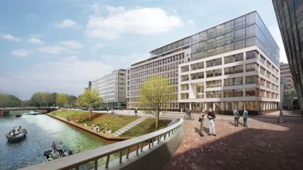 Moderne kantoorgebouwen aan de Catharijnesingel in Utrecht met mensen langs het water en boten in de gracht.