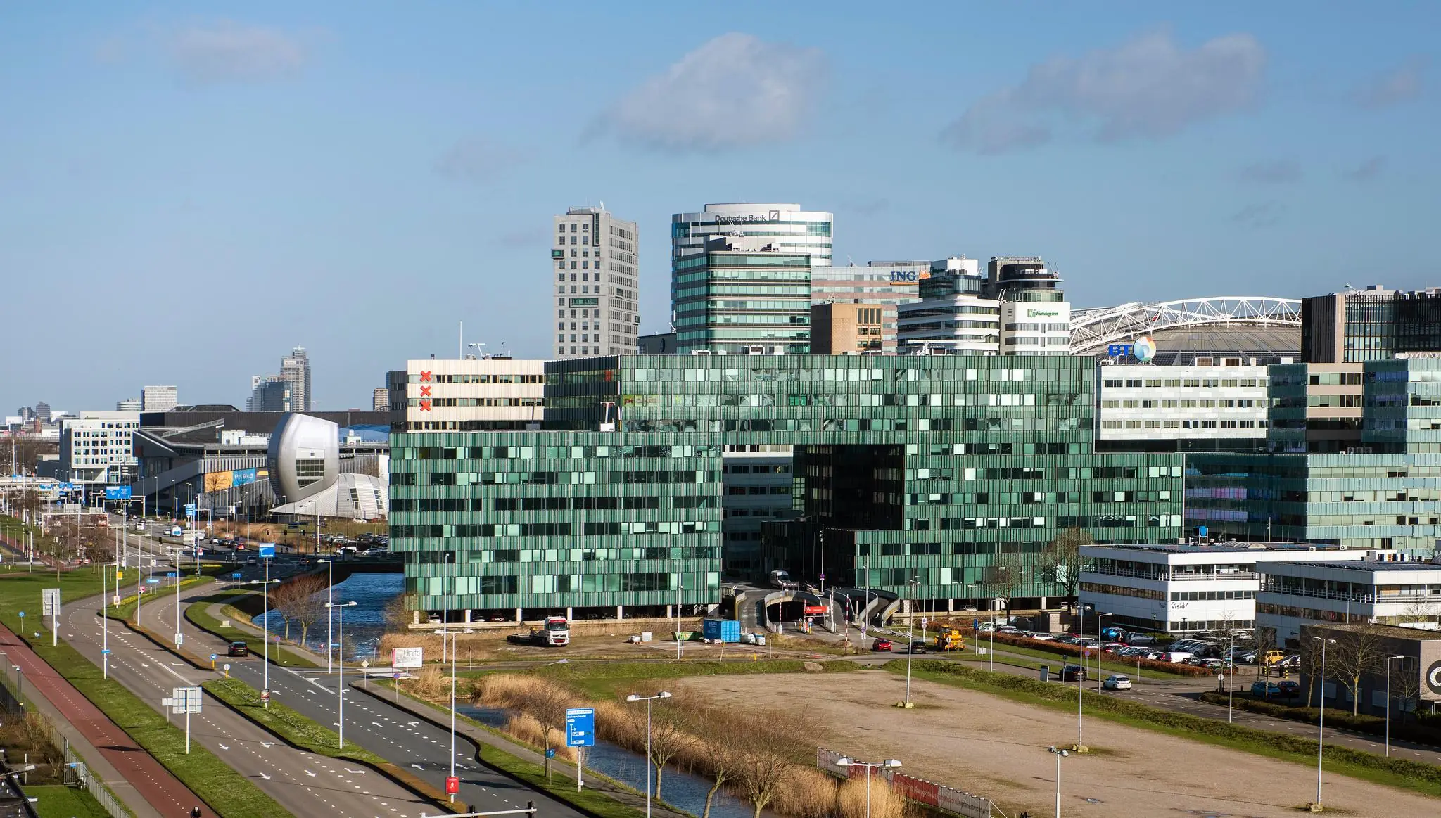 Kantoorgebouwen aan de Herikerbergweg in Amsterdam-Zuidoost met op de achtergrond de Amsterdam ArenA.