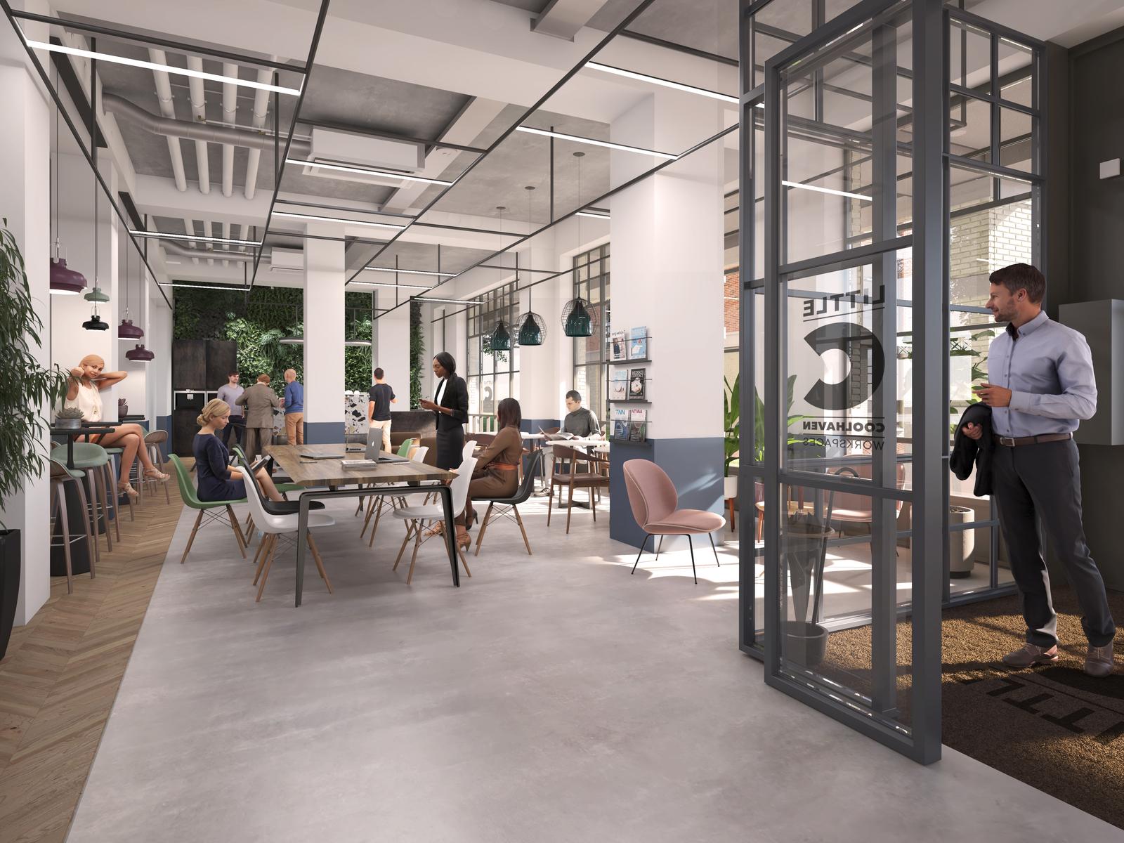 Een moderne co-working ruimte met meerdere mensen die aan tafels zitten en praten.