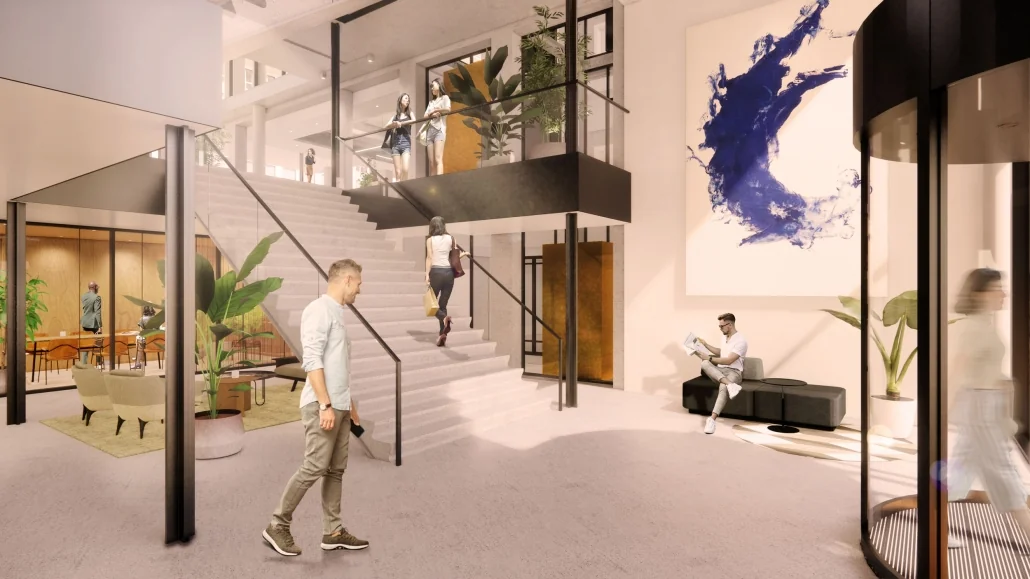 Moderne en lichte lobby aan de Catharijnesingel met een brede trap, zithoeken en kunst aan de muur.