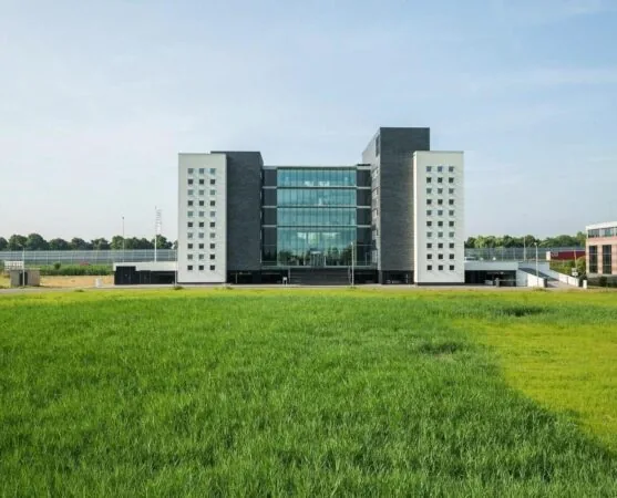 Modern kantoorgebouw Stationspark met glazen gevel, gezien vanaf een groen grasveld.