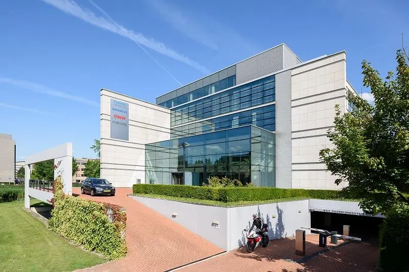 Modern kantoorpand aan de Polarisavenue met glazen entree, oprit en ondergrondse parkeergarage.