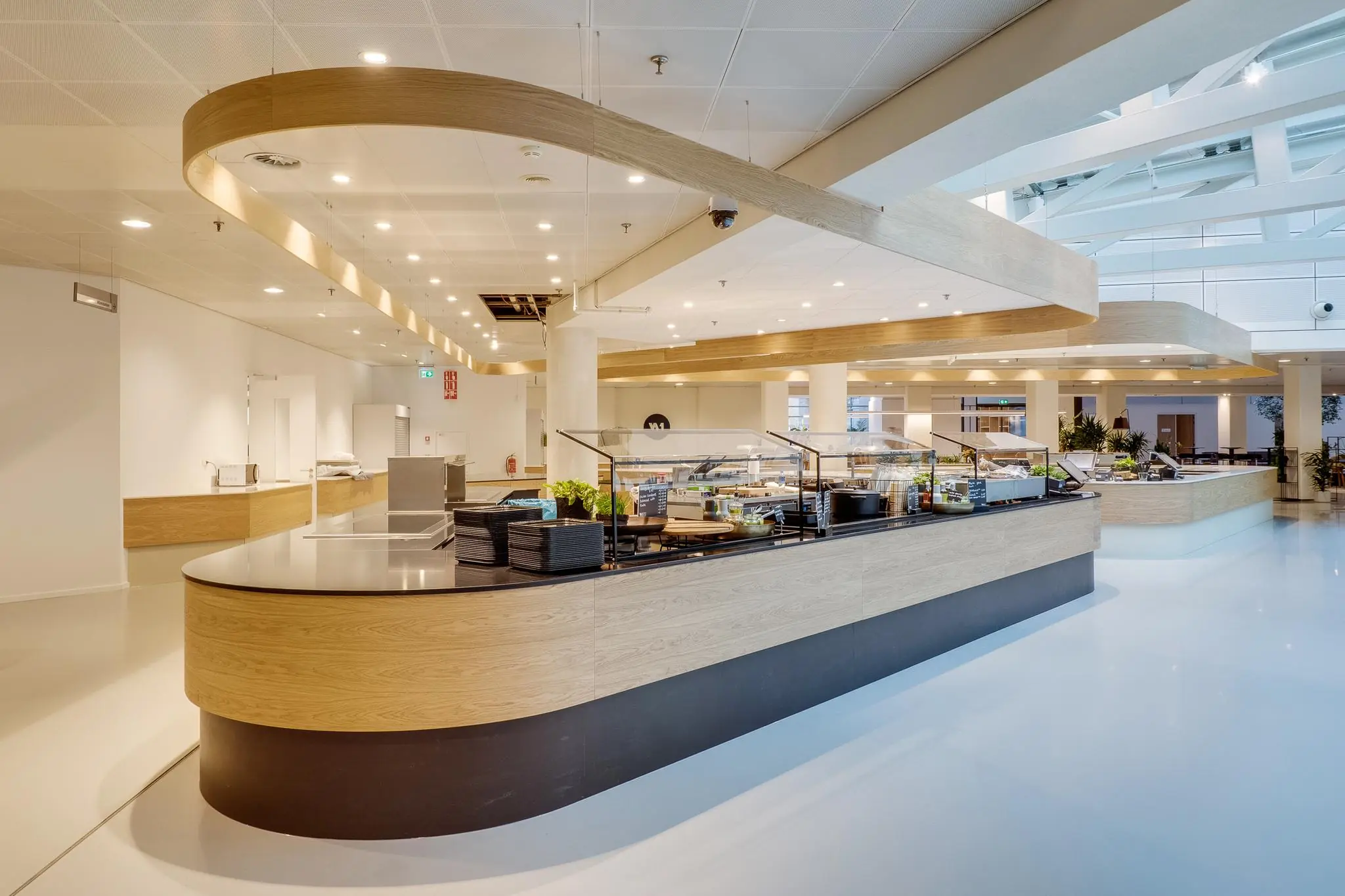 Modern bedrijfsrestaurant aan de Winthontlaan met een ruime, houten zelfbedieningscounter en veel natuurlijk licht.