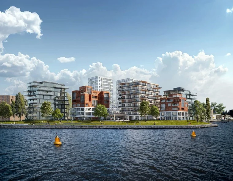 Moderne appartementencomplexen aan het water bij de Grasweg in Amsterdam, gezien vanaf de overkant van het kanaal.