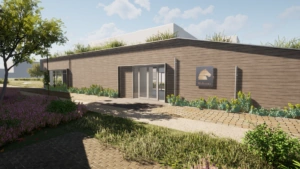 Een modern, houten gebouw met groendak en het logo van Mulvesia aan de gevel, omgeven door een groene tuin.