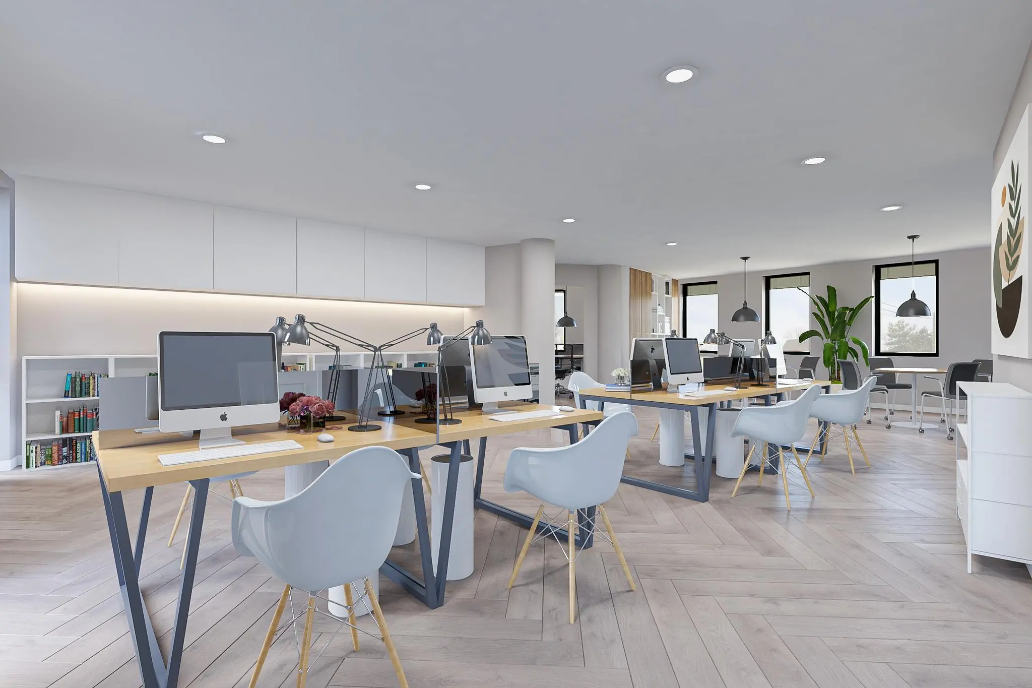 Modern ingericht kantoor aan de Koningsweg met open werkplekken, iMacs en veel natuurlijk licht.