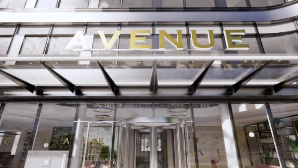 Ingang van het gebouw 'Avenue' aan de Europalaan met glazen deuren en een moderne gevel.