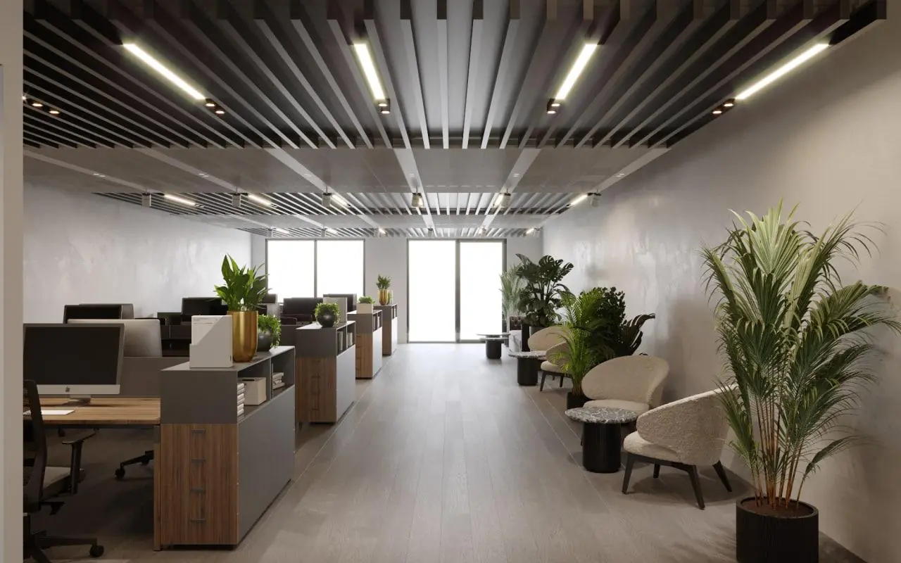 Modern kantoorinterieur aan de Grasweg met werkplekken, loungehoek en veel groen.