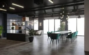 Moderne vergaderruimte aan de Grasweg met een lange tafel, groene stoelen, plafondverlichting en grote ramen.