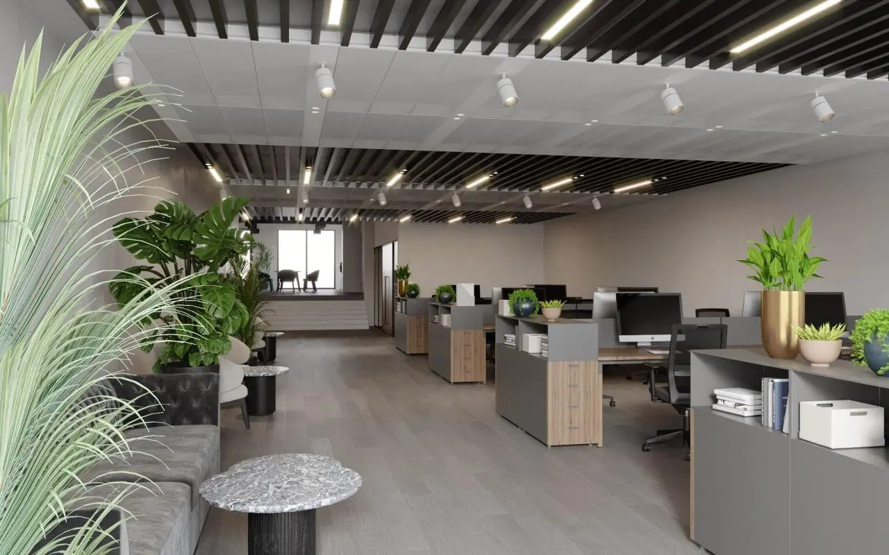 Modern kantoorinterieur aan de Grasweg met open werkplekken, veel planten en strakke inrichting.