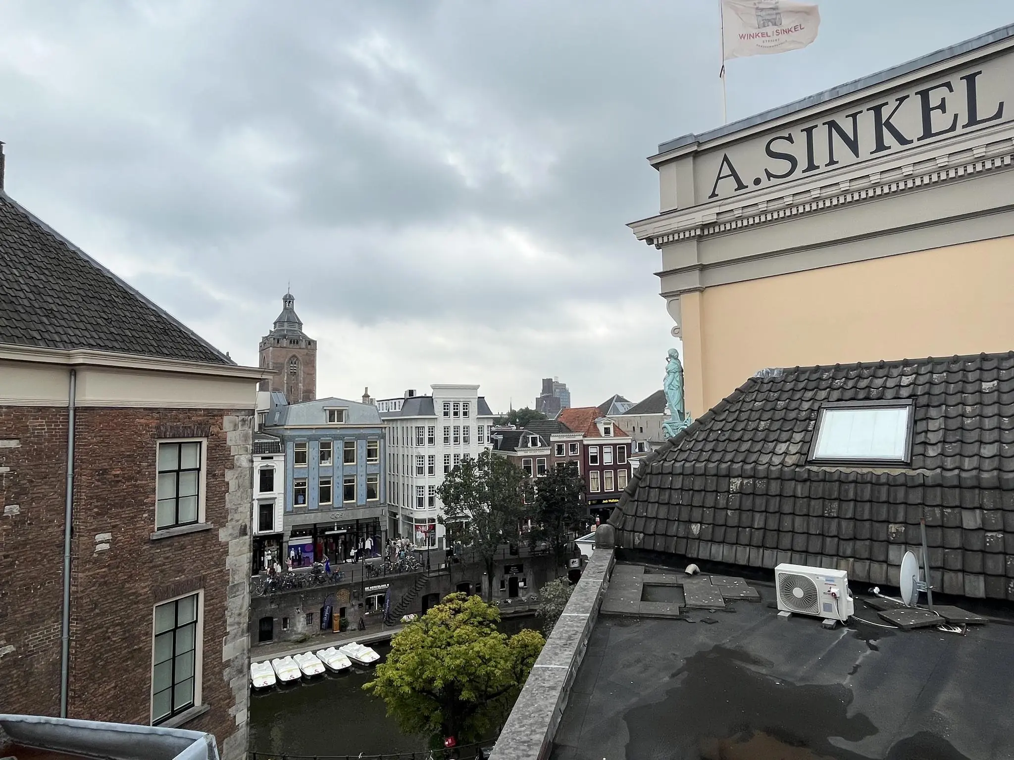 Uitzicht op de Ganzenmarkt in Utrecht met zicht op de Oudegracht en het historische pand Winkel van Sinkel.