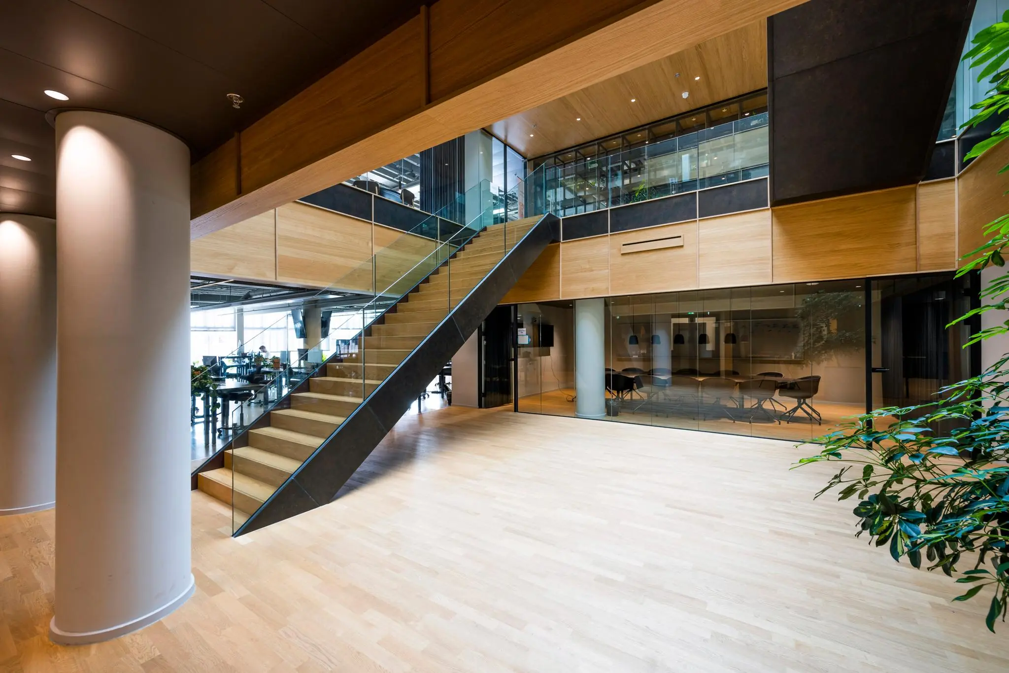 Moderne kantoorruimte aan het Rokin met houten trap, glazen wanden en vergaderruimte.