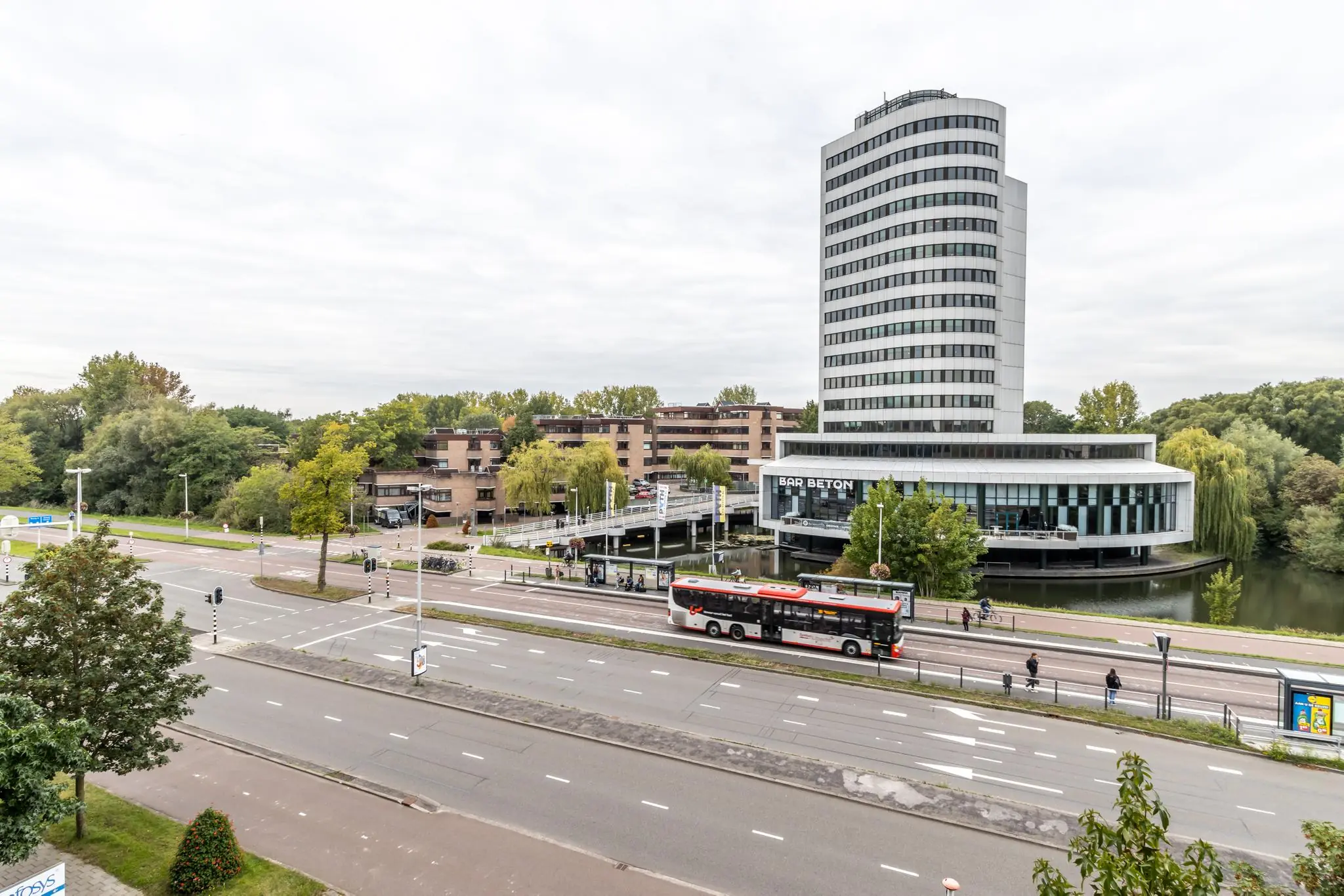 Kantoorgebouw aan de Pythagoraslaan in Utrecht met Bar Beton, appartementencomplex en rijdende stadsbus op de voorgrond.