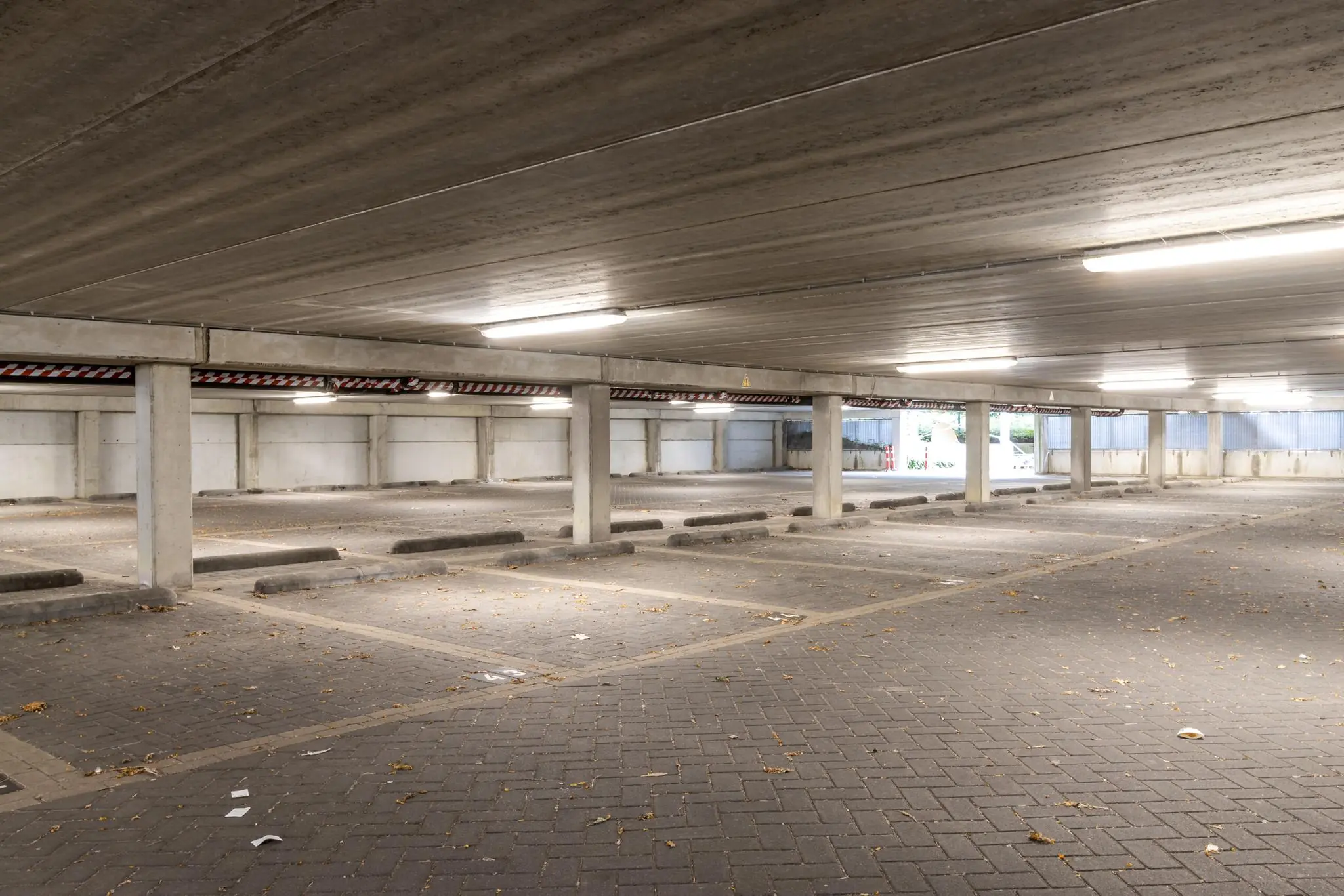 Lege overdekte parkeergarage aan de Pythagoraslaan met betonnen pilaren en tl-verlichting.