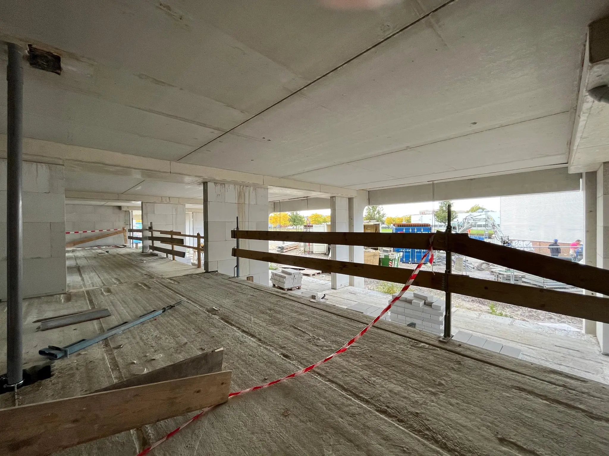 Binnenzijde van een betonnen bouwconstructie aan de Cartesiusweg in aanbouw, met houten hekwerken en bouwmaterialen.