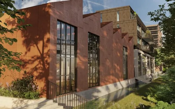 Moderne woon- en kantoorgebouw aan de Papaverweg met grote ramen en een roodbruine gevel, omgeven door groen.