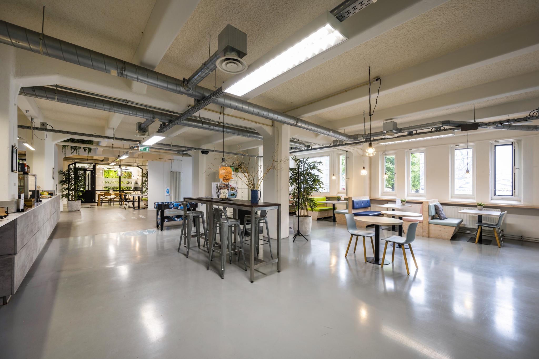 Moderne en open kantoorruimte aan de Van Diemenstraat met zitgedeeltes, hoge tafels en veel daglicht.