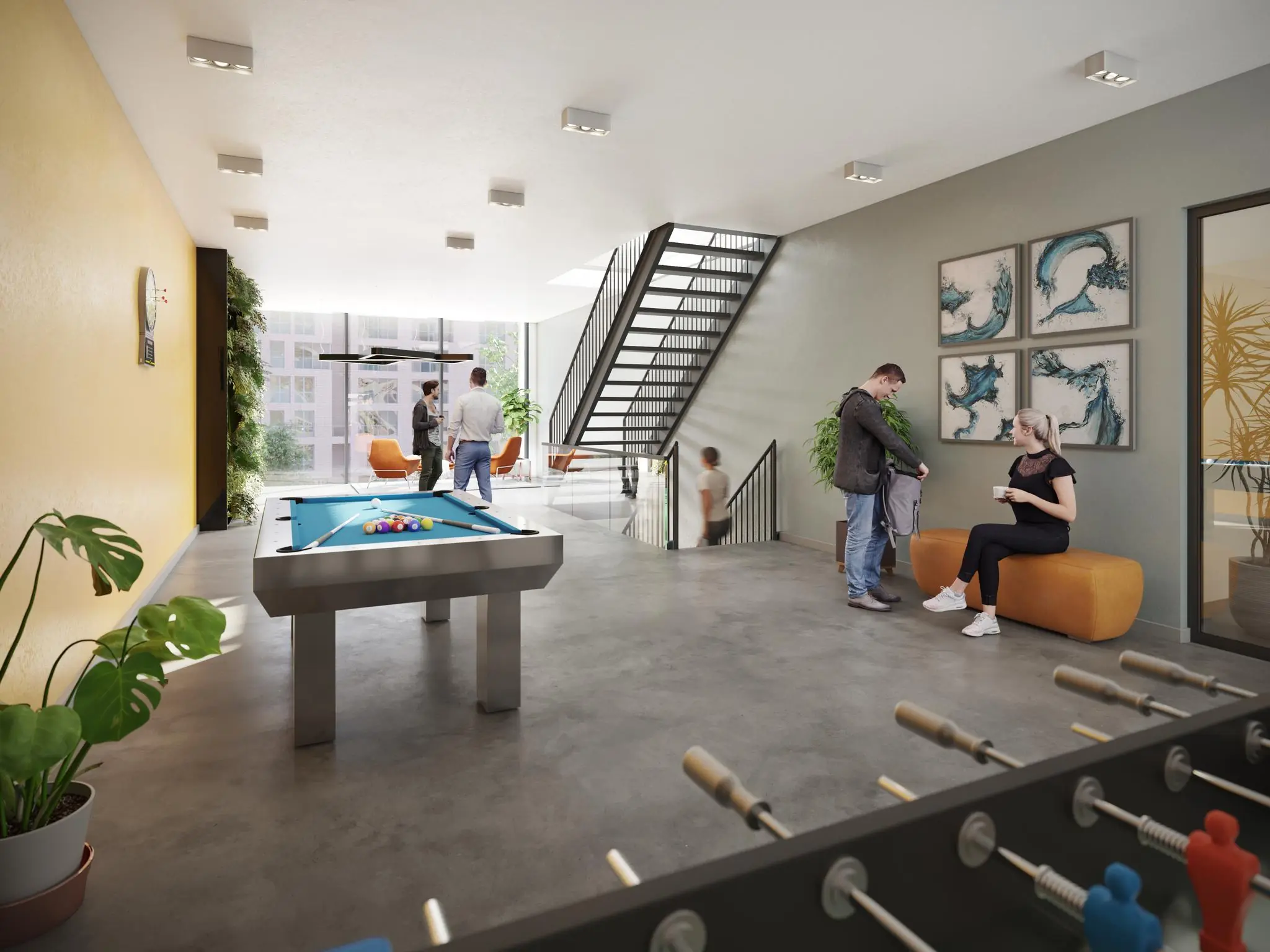 Moderne gemeenschappelijke ruimte aan de Treubstraat met pooltafel, tafelvoetbal en zithoeken waar mensen ontspannen en met elkaar praten.