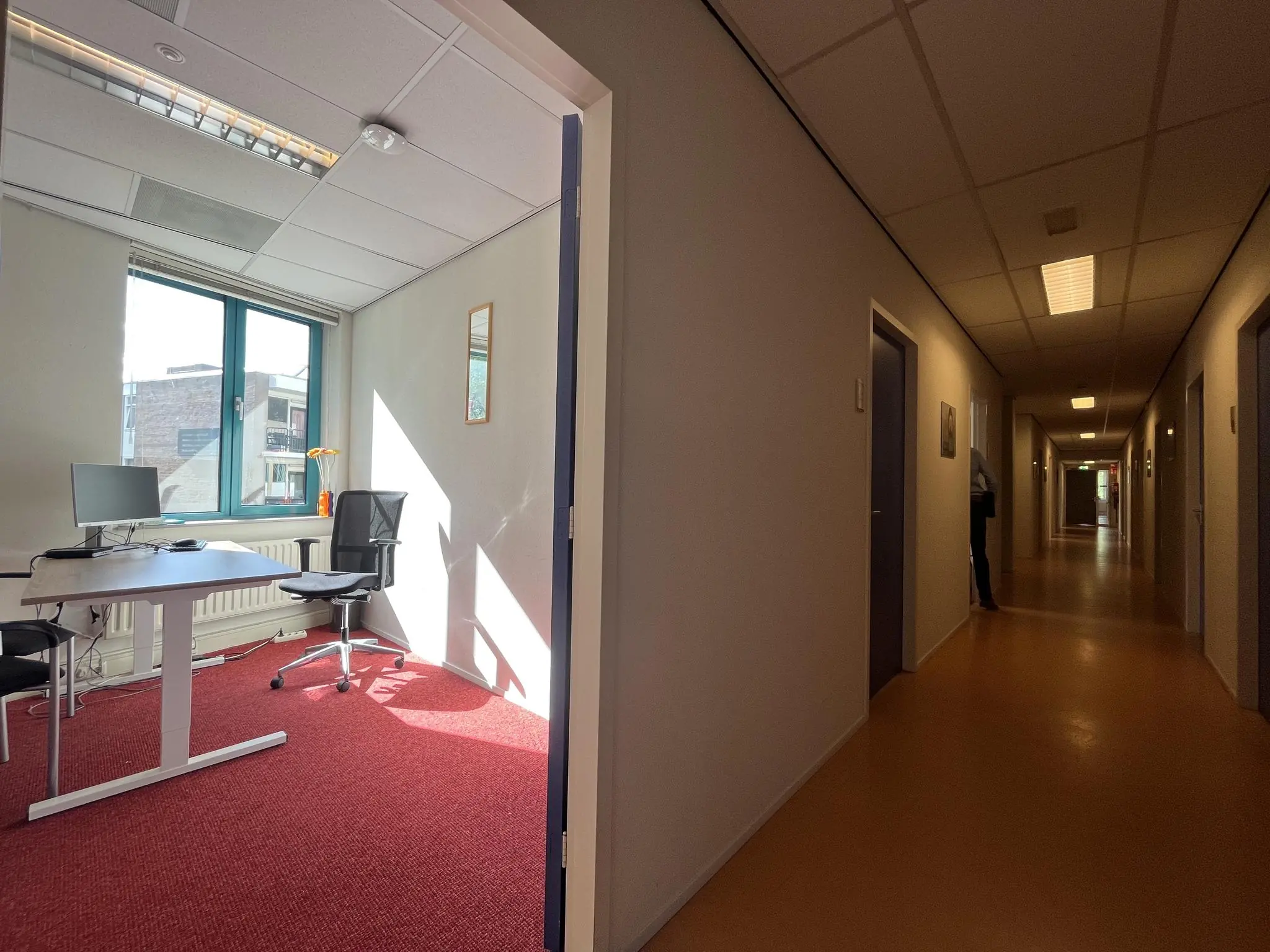 Verlichte kantoorruimte in Zoutkamper Schans met een open deur naar een gang.