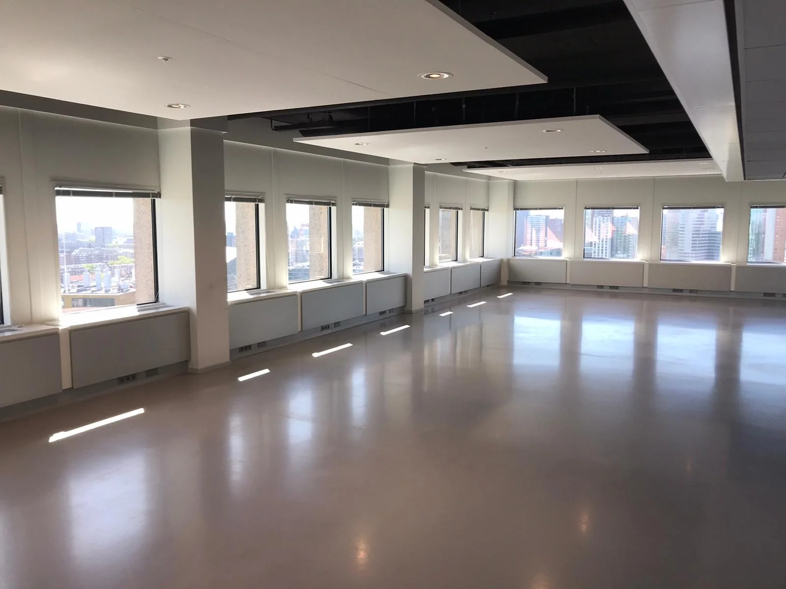 Licht en leeg kantoorpand aan het Hofplein met panoramisch uitzicht over de stad.