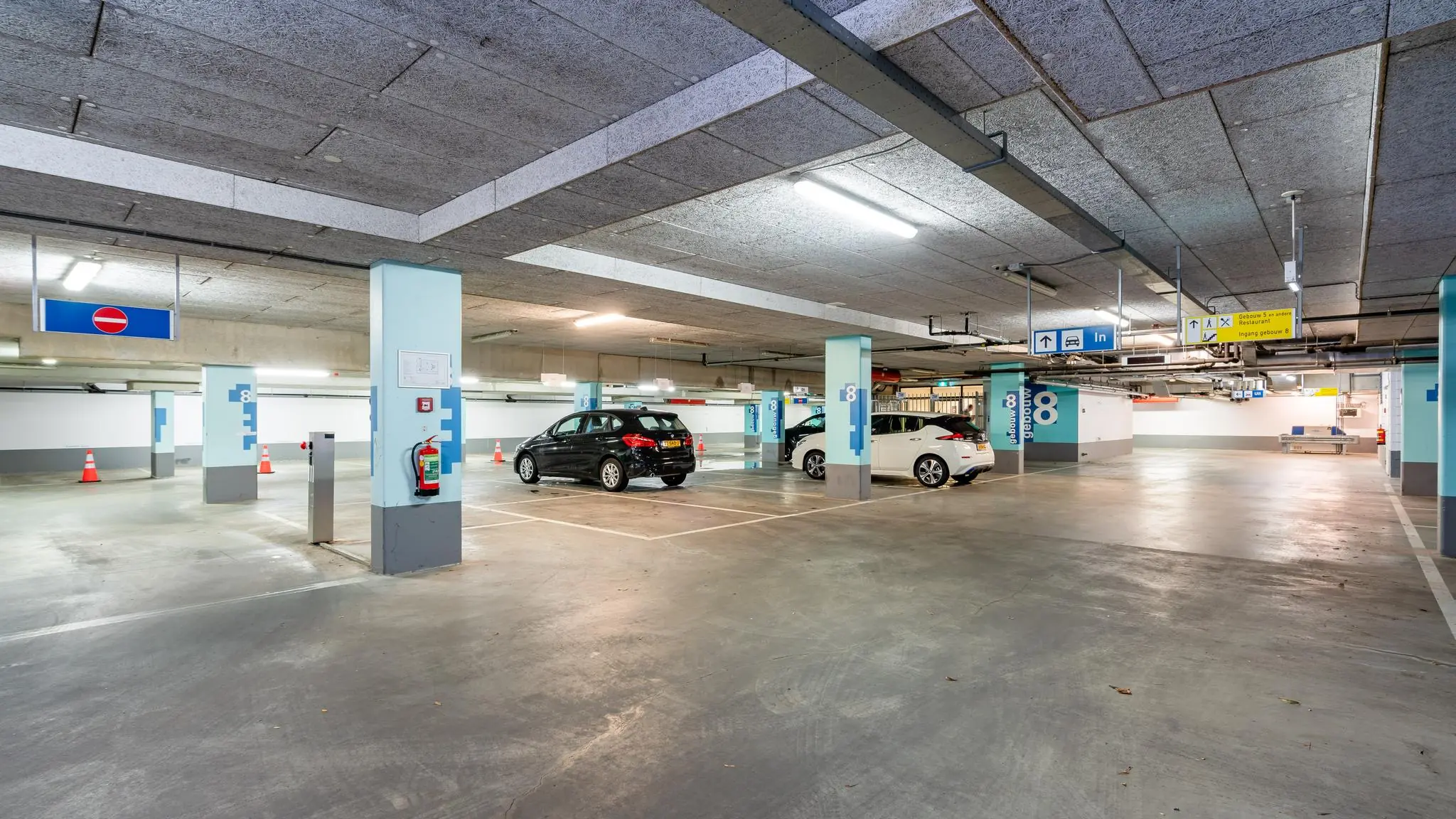 Ondergrondse parkeergarage Maanplein met geparkeerde auto's en duidelijke bewegwijzering.