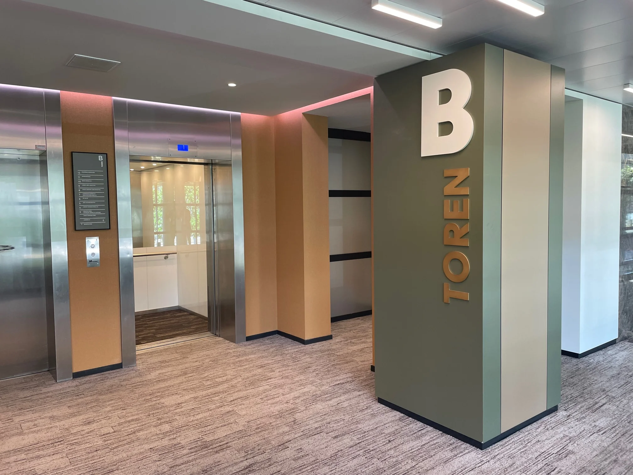 Liftlobby van Toren B in het kantoorgebouw aan het Weena, met openstaande liftdeuren en moderne afwerking.