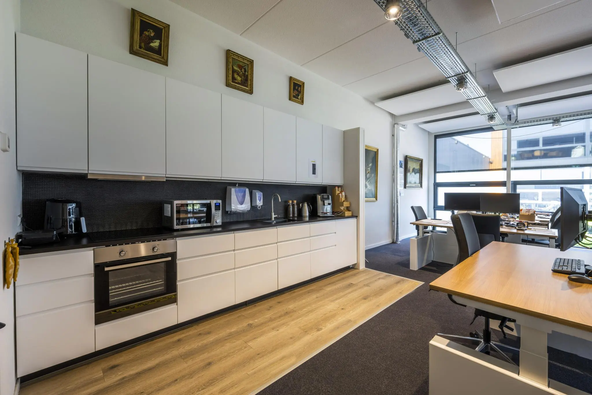 Moderne kantoorruimte met een open keuken en werkplekken aan de Asterweg.