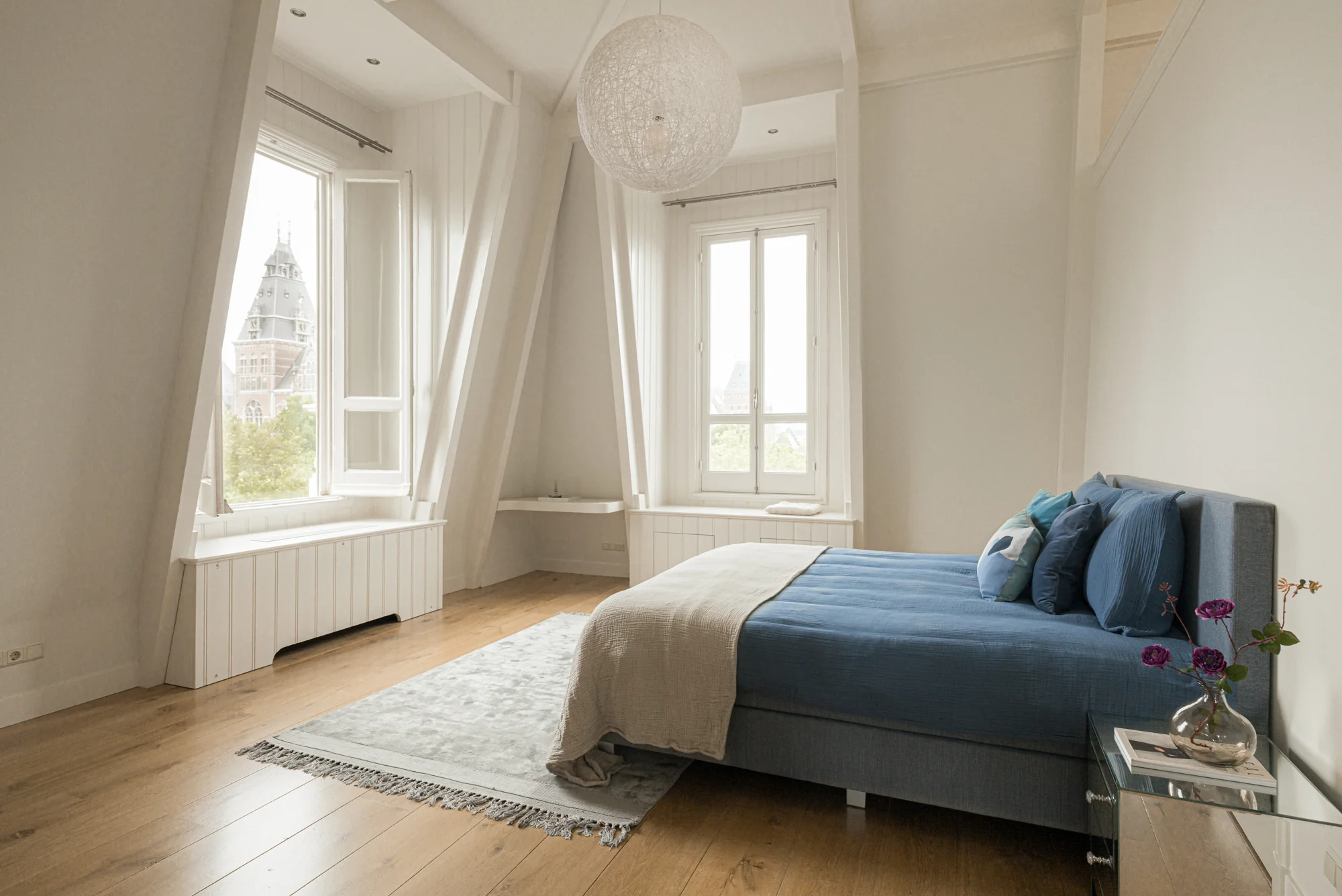 Licht en modern ingerichte slaapkamer op de Weteringschans met uitzicht op het Rijksmuseum.