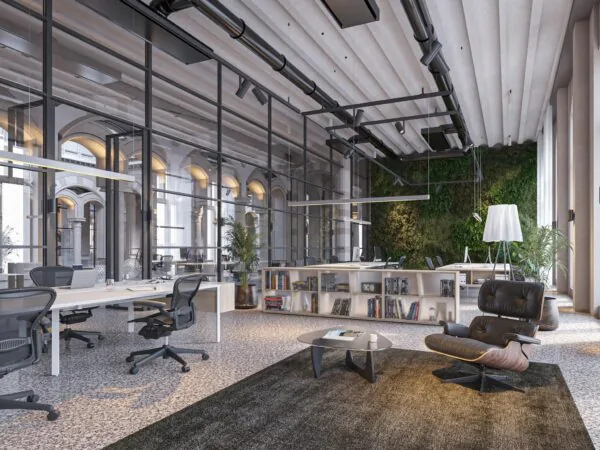 Modern kantoorinterieur aan de Nieuwezijds Voorburgwal met open werkplekken, glazen wanden en een groene plantenmuur.