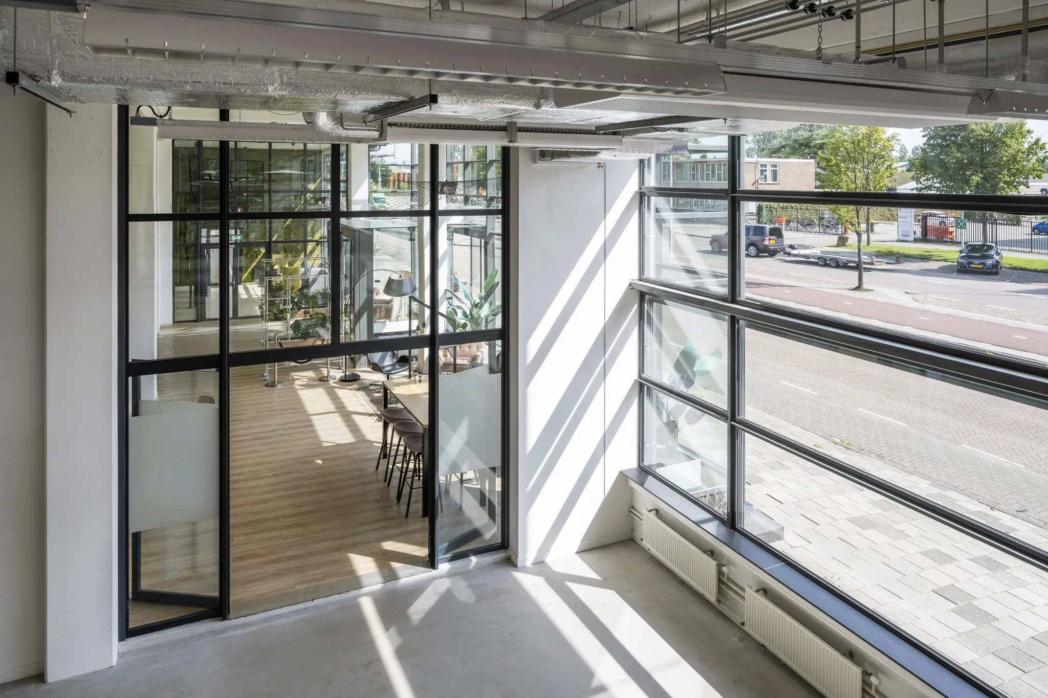 Moderne kantoorruimte aan de Kabelweg met glazen wanden en uitzicht op de straat.
