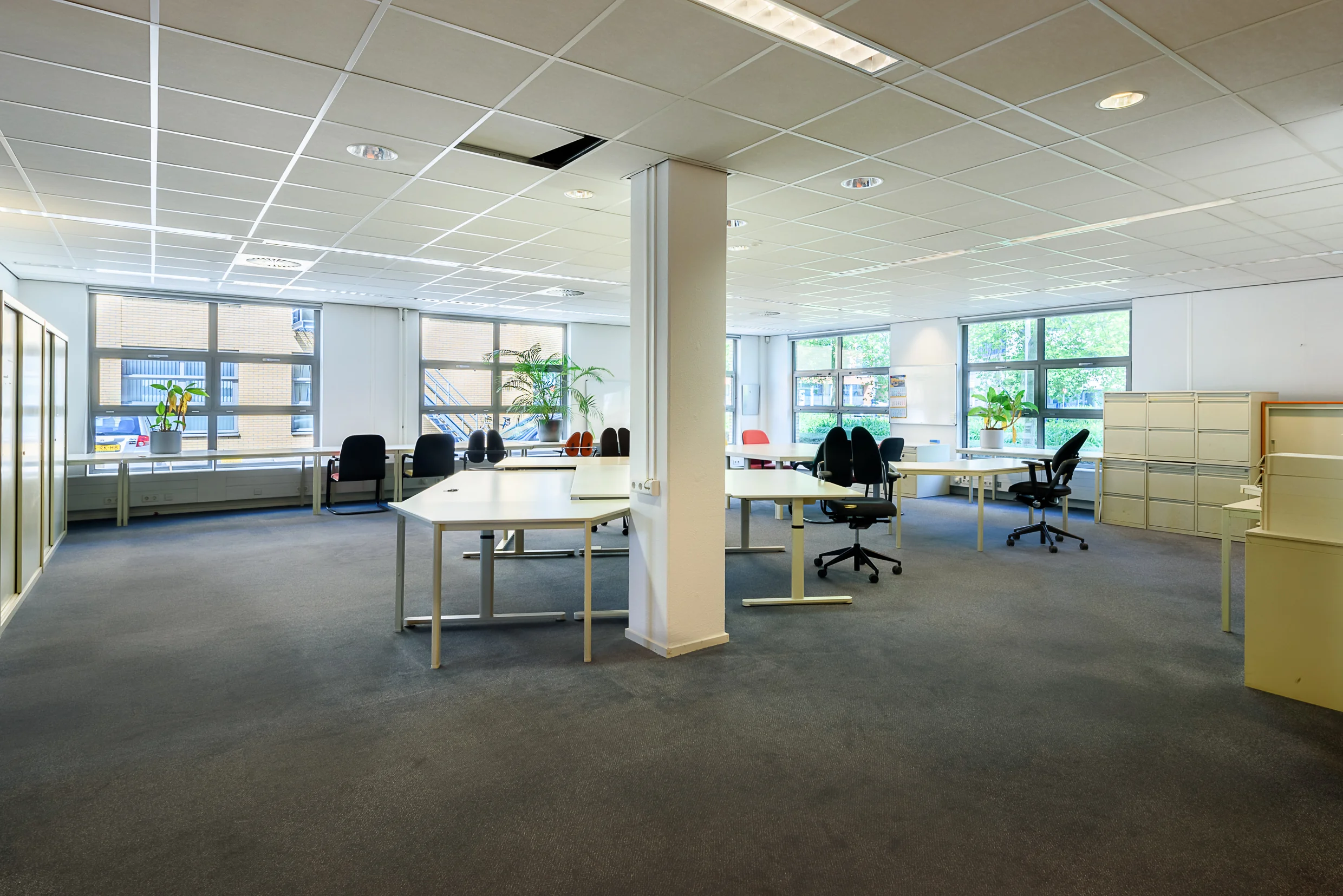 Ruime, lichte kantooretage in Capelle aan den IJssel met meerdere werkplekken en grote ramen.