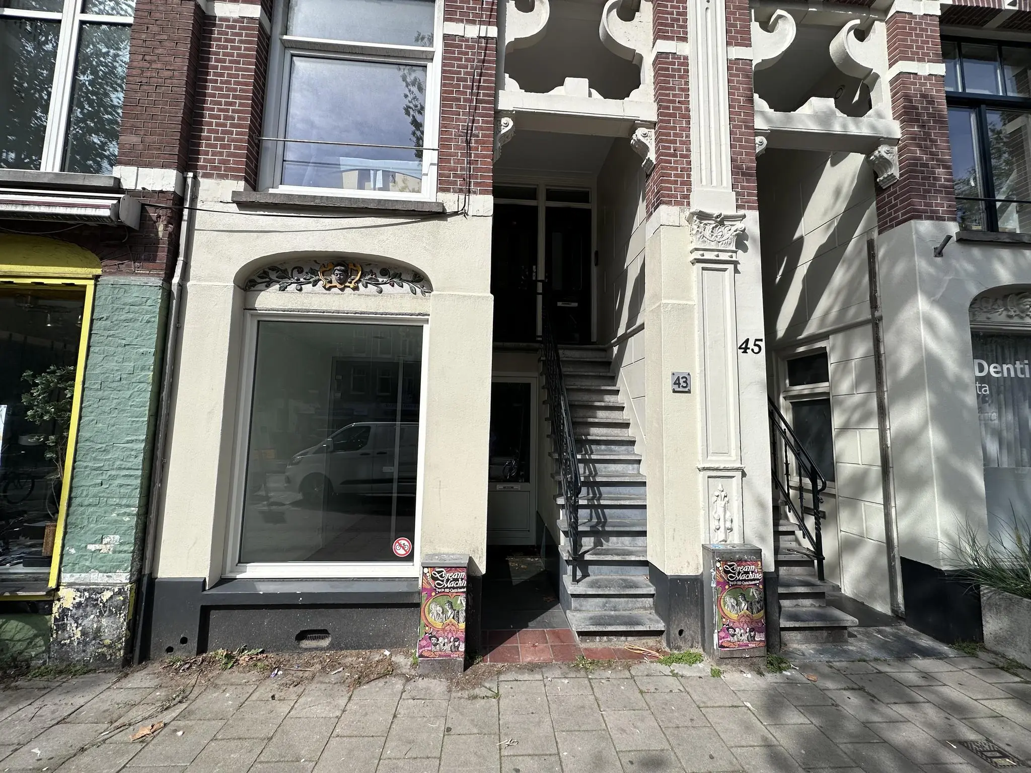 Voorgevel van een pand aan de Ceintuurbaan met huisnummers 43 en 45, brede trapopgang en versierde prullenbak op de stoep.