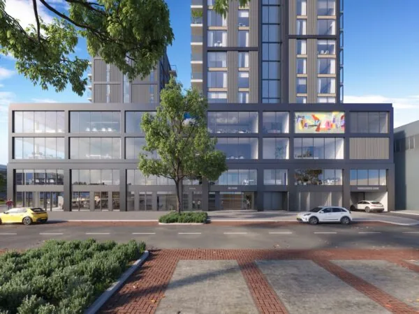 Moderne hoogbouw aan de Melkwegstraat met glazen gevel, winkels op de begane grond en geparkeerde auto’s ervoor.