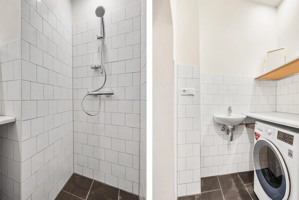 Moderne badkamer op de Westerstraat met een betegelde inloopdouche, wastafel en wasmachine.