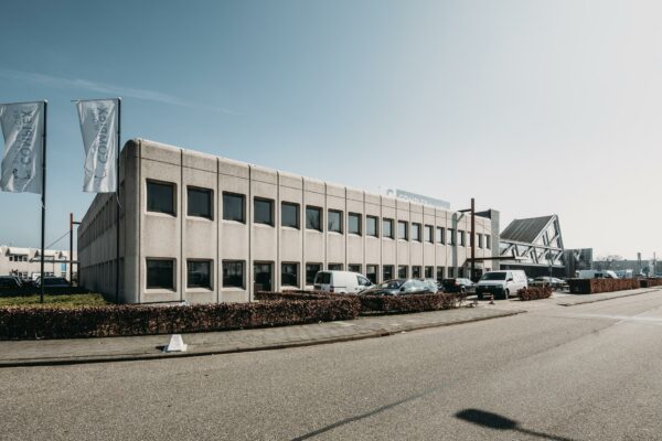 Kantoorpand aan de Meidoornkade met parkeerplaatsen en vlaggen van bedrijvencentrum Complex.