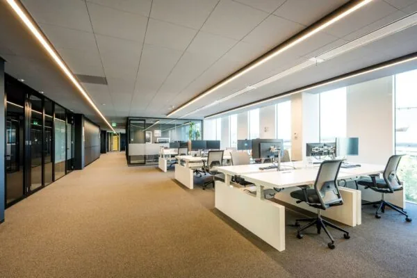 Moderne open kantoorruimte in kantoorgebouw Hoekenrode met werkplekken en glazen wanden.