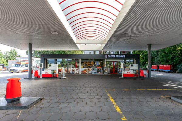 Tankstation AVIA aan de Birkstraat met overkapping, pompen en een Coffee Fellows winkel op de achtergrond.