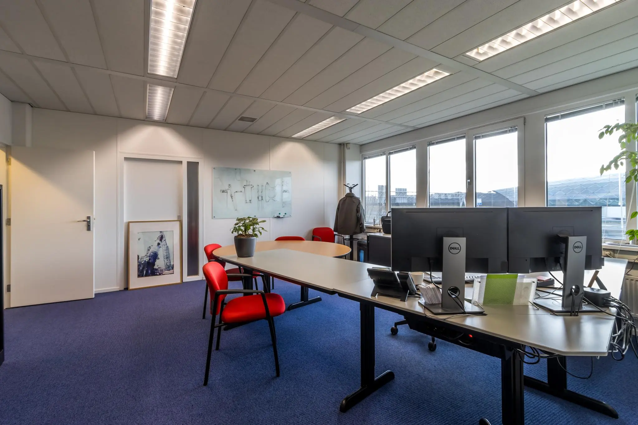 Modern kantoor op de Savannahweg met werkplekken, vergadertafel en grote ramen.