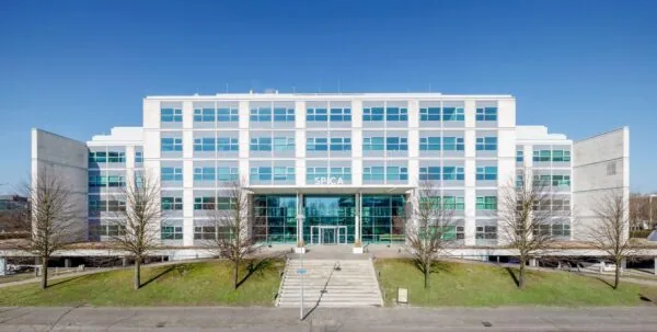 Moderne kantoorgebouw genaamd SPICA aan de Spicalaan, gefotografeerd vanaf de voorkant op een zonnige dag.