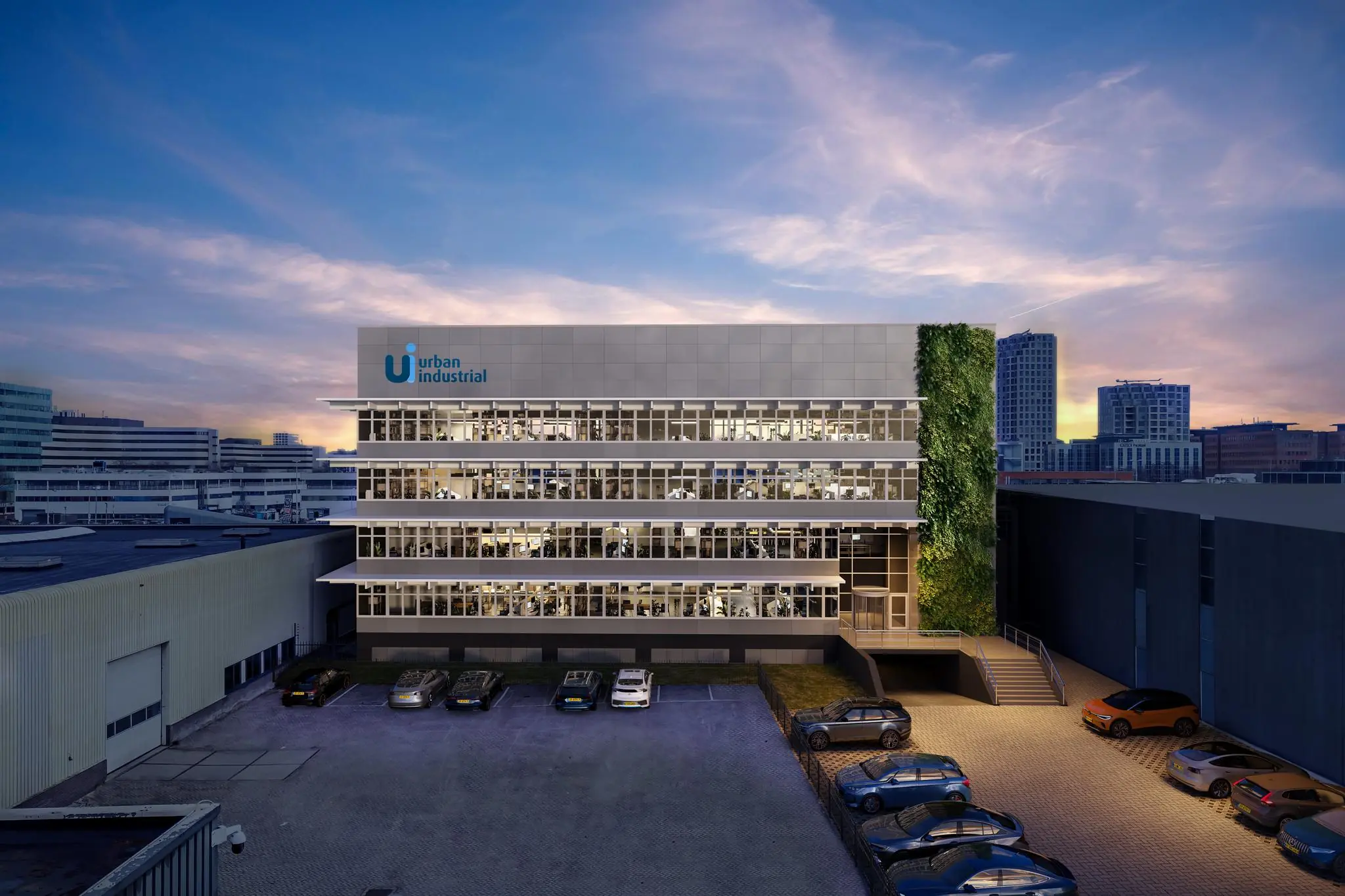Kantoorgebouw aan de Lemelerbergweg met Urban Industrial-logo en groene gevel, gefotografeerd bij zonsondergang.