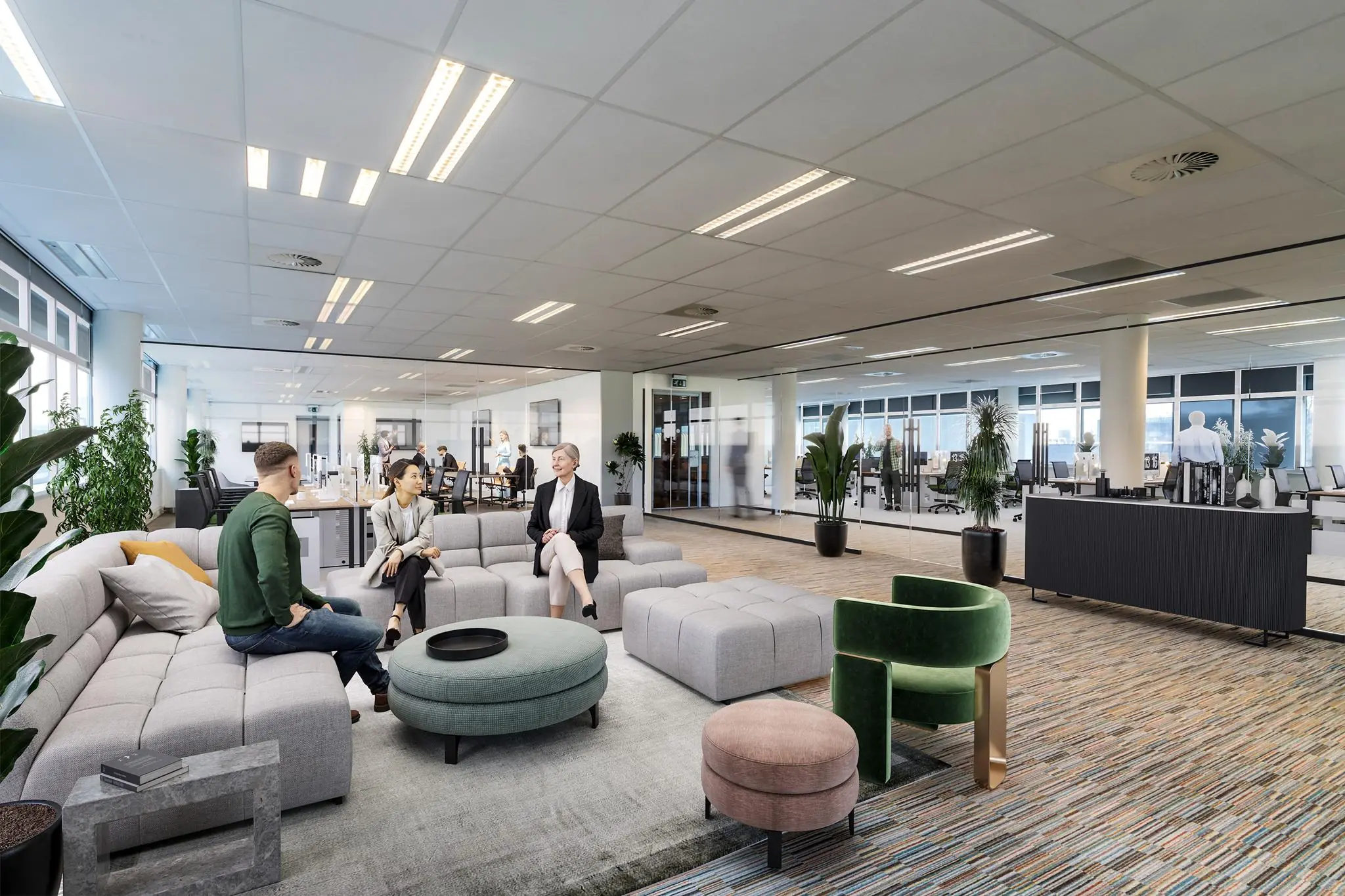 Moderne kantoorruimte aan de Lemelerbergweg met mensen in gesprek in een open loungegedeelte.