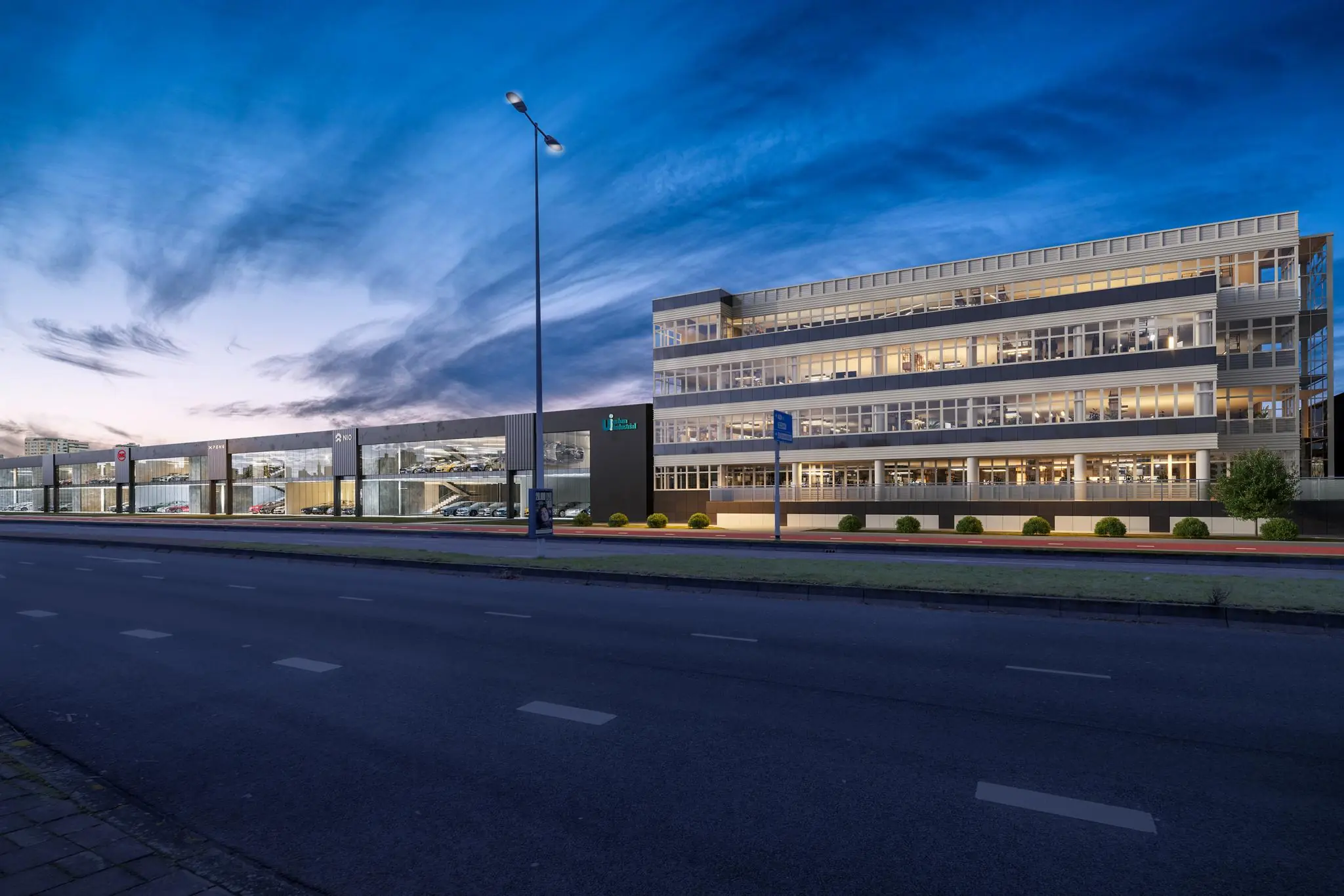 Modern kantoorgebouw en autoshowroom aan de Lemelerbergweg in Amsterdam tijdens de schemering.