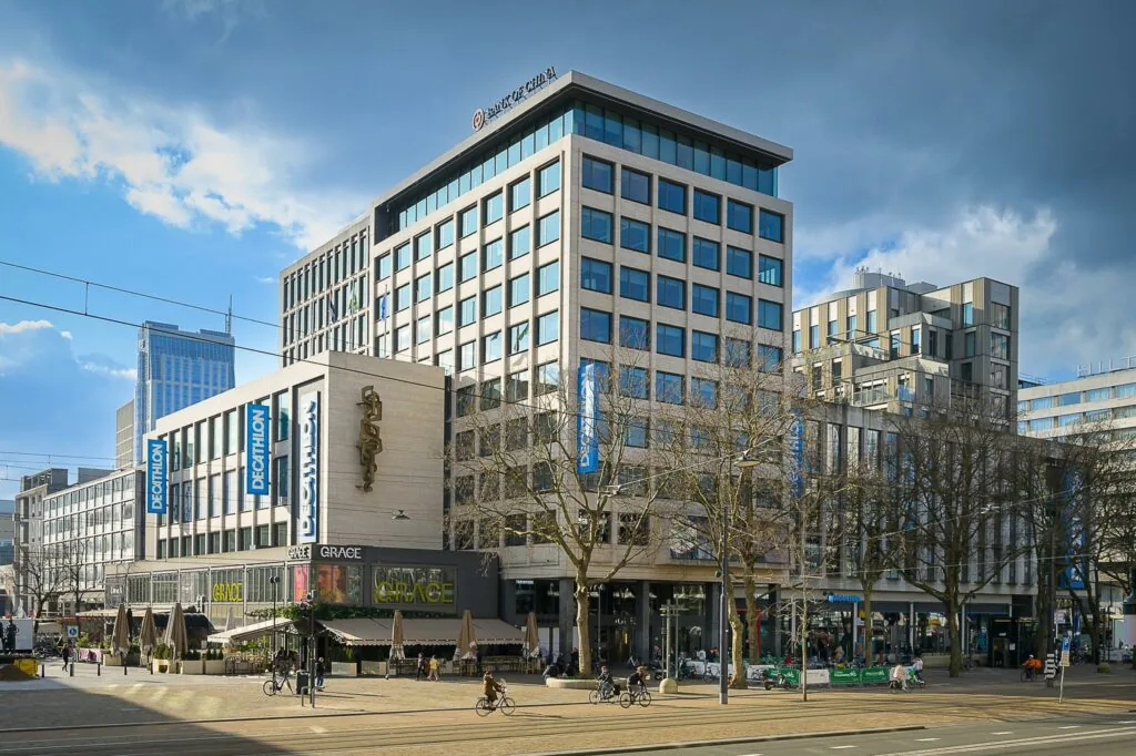 Straatbeeld van de Coolsingel in Rotterdam met het opvallende gebouw van de Bank of China, Decathlon en restaurant Grace.