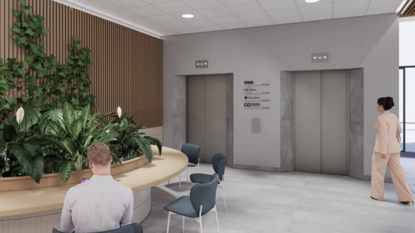 Moderne wachtruimte bij de liften op het Stationsplein met planten, zitplekken en bewegwijzering naar bedrijven in het gebouw.