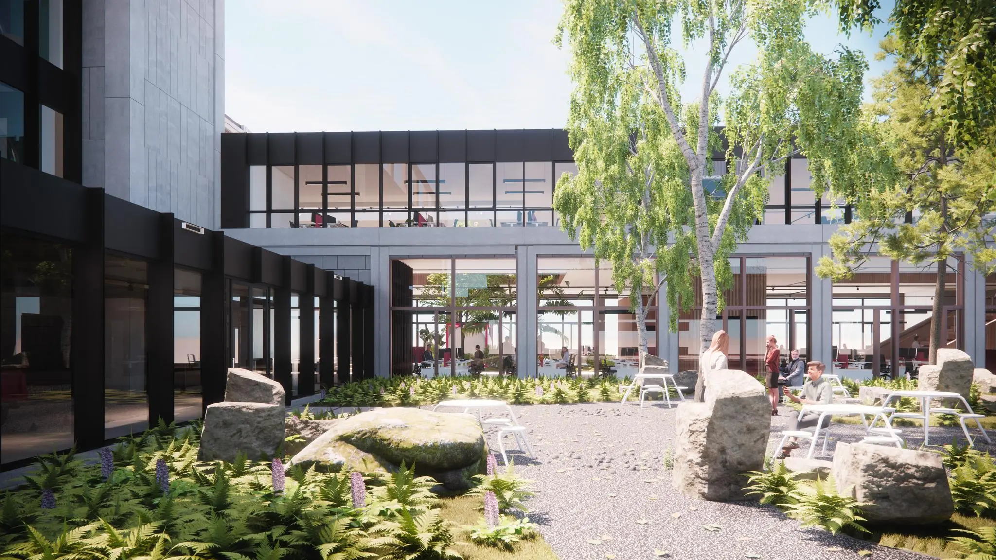 Moderne binnentuin met zitplekken, groen en grote ramen aan het gebouw aan de Sluisjesdijk.