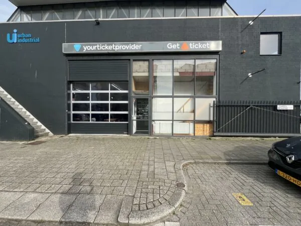 Vooraanzicht van een bedrijfsgebouw aan de Eendrachtlaan met logo’s van Yourticketprovider en Get a Ticket.